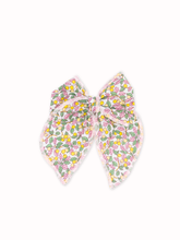 Load image into Gallery viewer, Pair of floral bow earrings on a white background