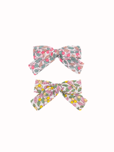 Load image into Gallery viewer, Two floral-patterned hair bows on a white background