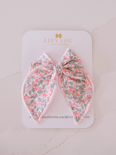 Load image into Gallery viewer, Floral hair bow on a LIVY LOU branded card with a light background
